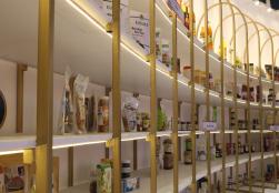 More than 500 Processed Food Products by PMFME Scheme Beneficiaries Showcased at the MoFPI Pavilion Product Display Wall.